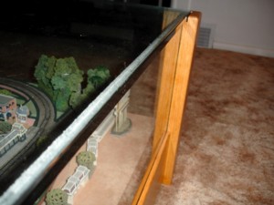 Close-up of the front of the table.  You can see the grooves the glass fit into and the weather stripping work to seal the table.
